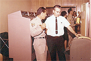 Photo of men in front of computer room